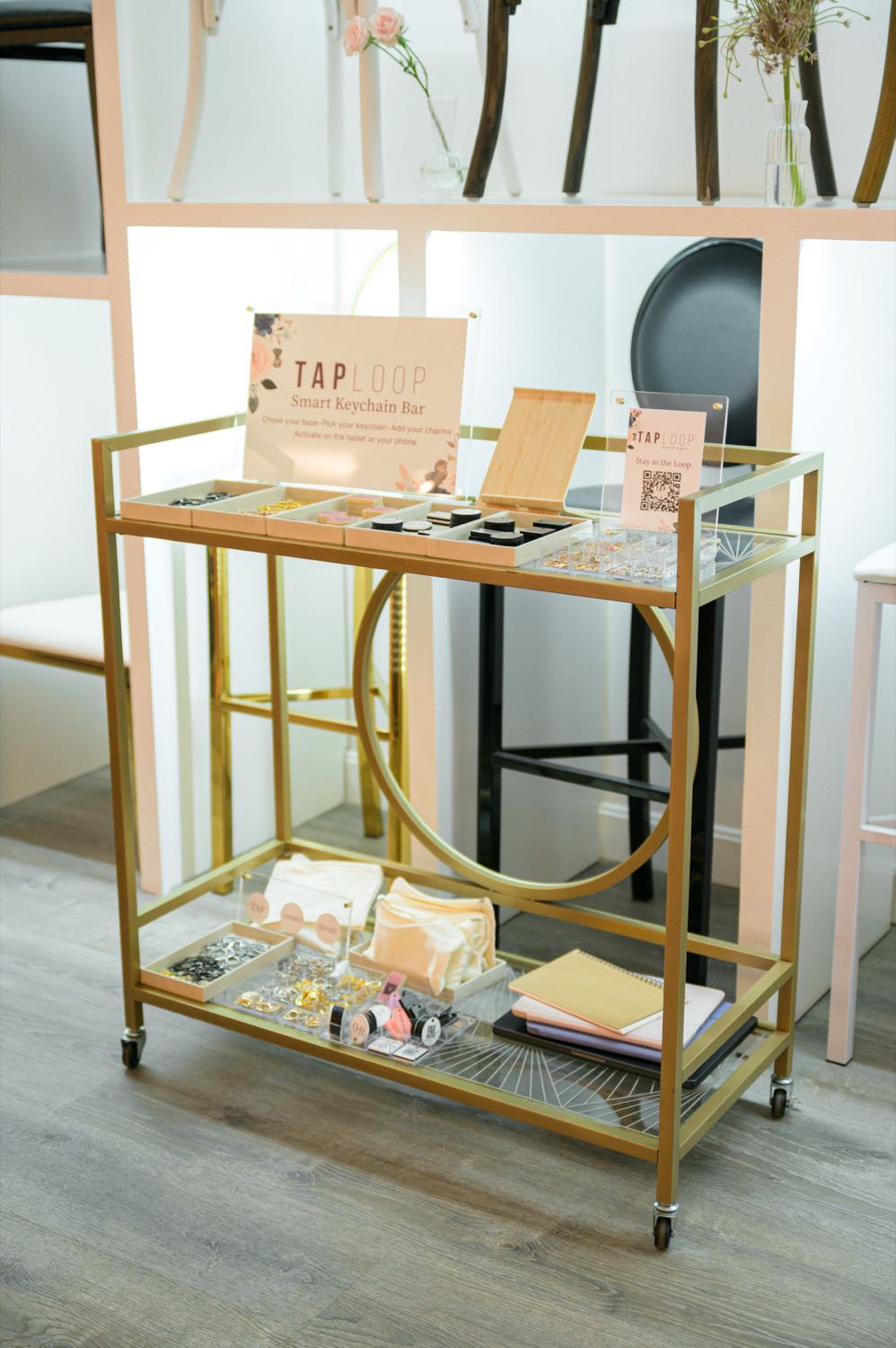 The full TapLoop keychain bar cart at a live event — branded signage, component trays, and a Stay in the Loop QR sign