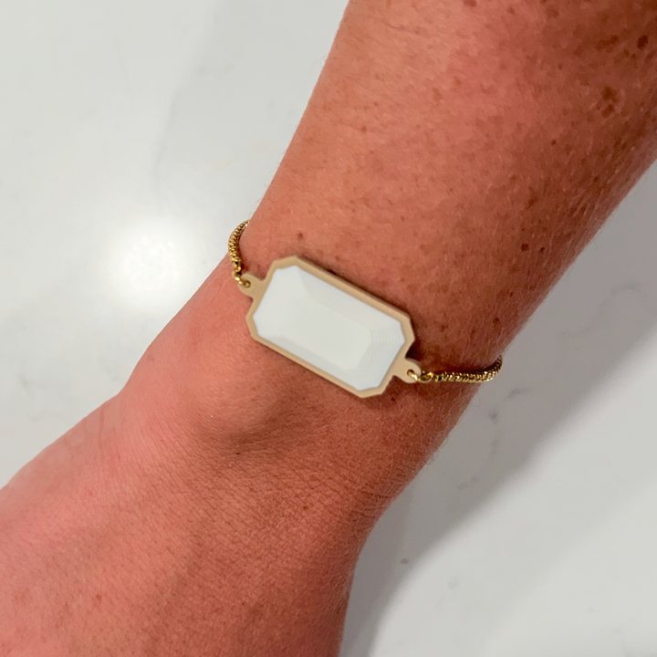 A TapLoop bracelet with a white stone, worn on a wrist