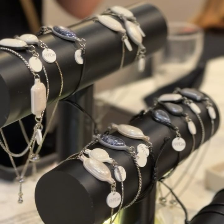 TapLoop bracelets in white and blue on a display stand